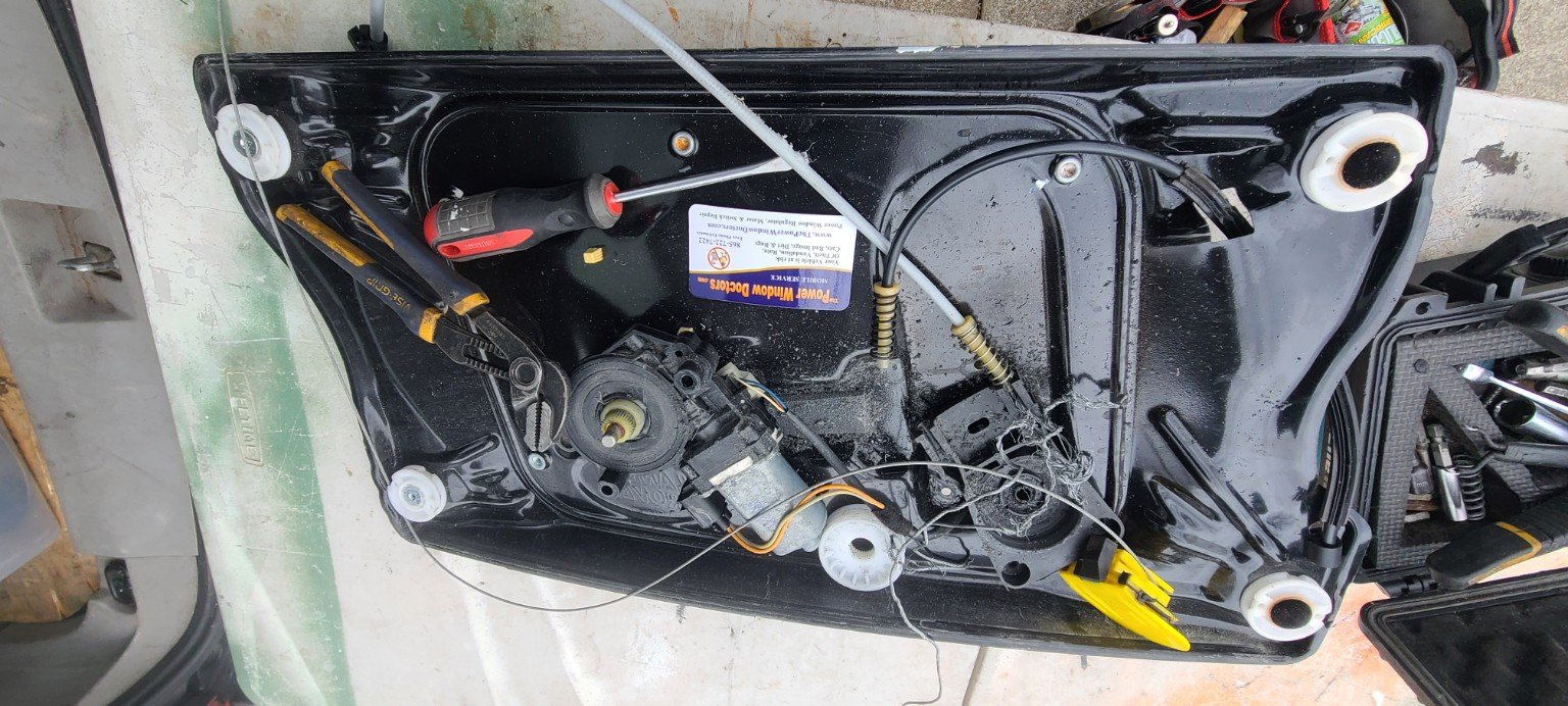 Automotive power window regulator assembly removed for repair